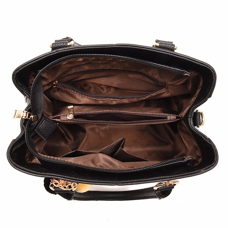 Interior view of a luxury handbag for women, showing spacious compartments and a rich brown lining.